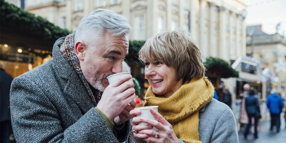 an older couple enjoynig coffee together