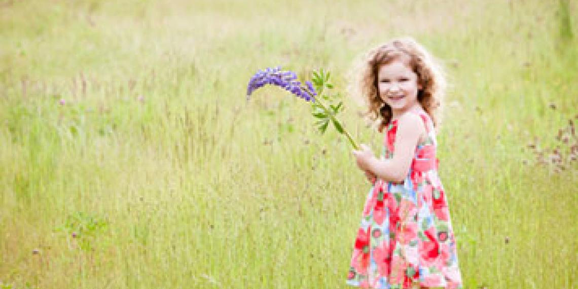 little girl holding flowers