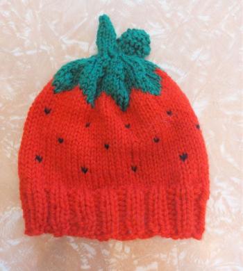 knitted woollen beanie shaped like a strawberry