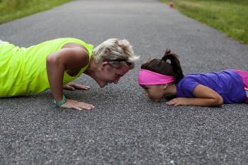 Woman and daughter doing push ups